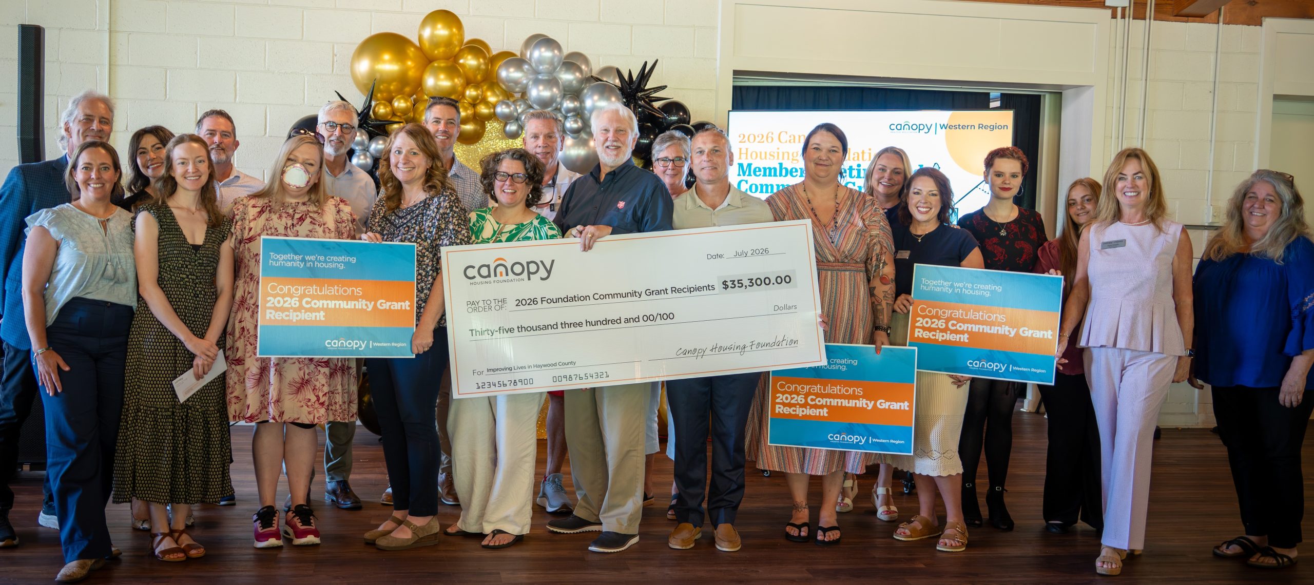 Western Region Community Grants Awarded at Celebration. Attendees hold "big check" in the amount of $26,000.
